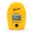Photo of yellow probe with flip top cover, button, and digital display